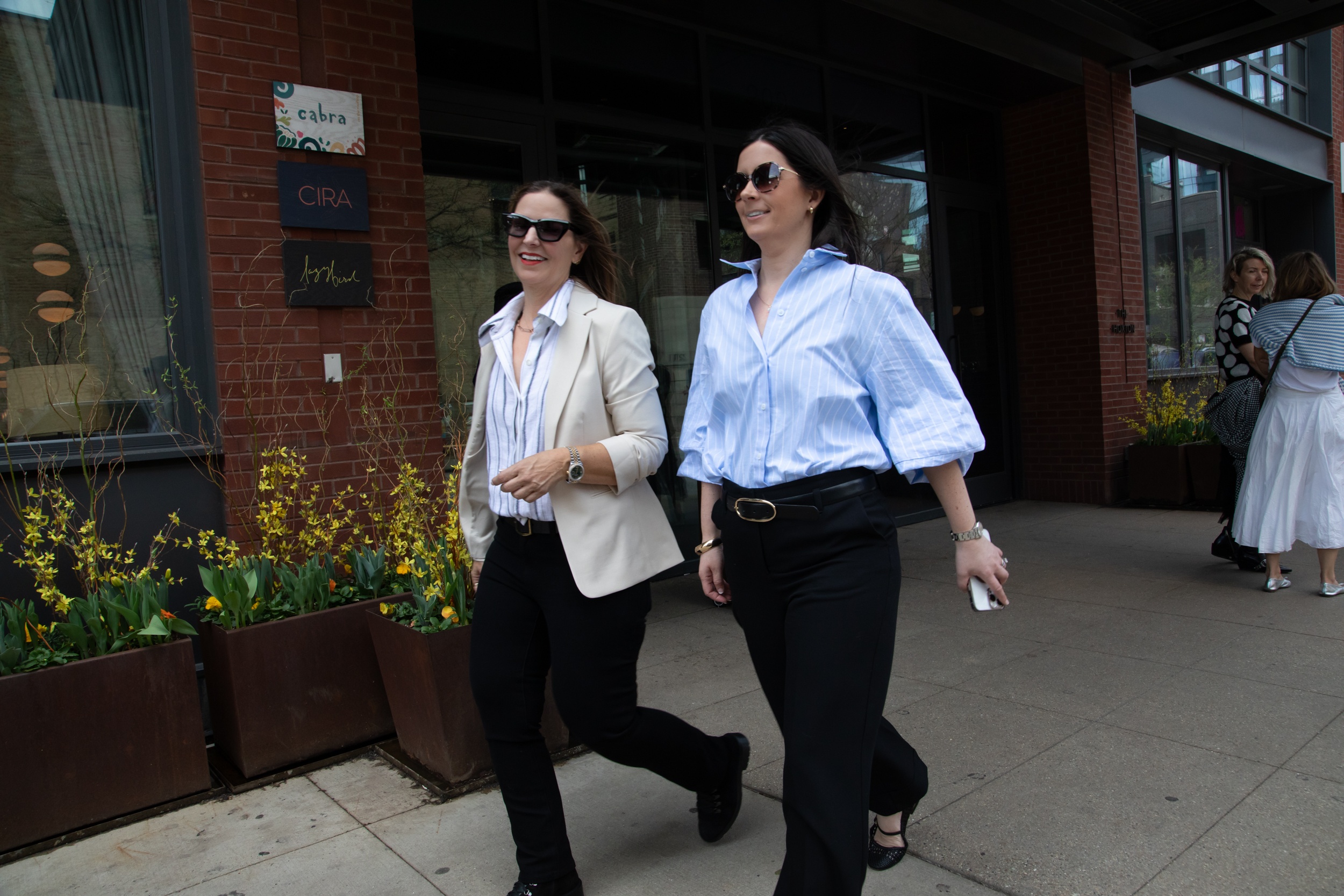 Lynnette Leathers and Jeanne Campbell of mindspot walking in downtown Chicago, representing their "we show up" approach to client research.